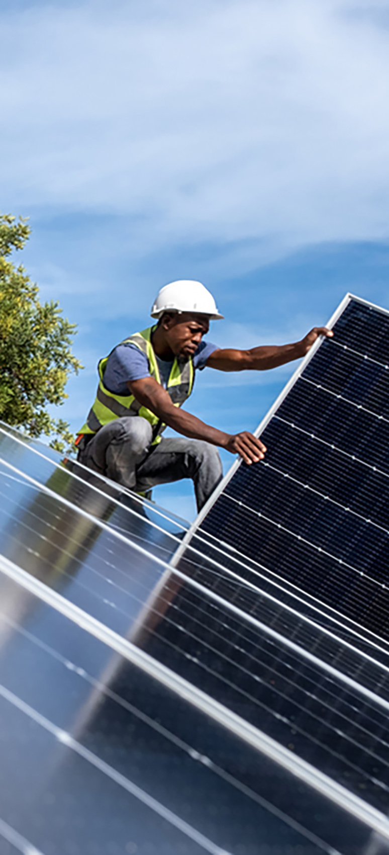 Skilled black engineer installing a roof top solar solution.